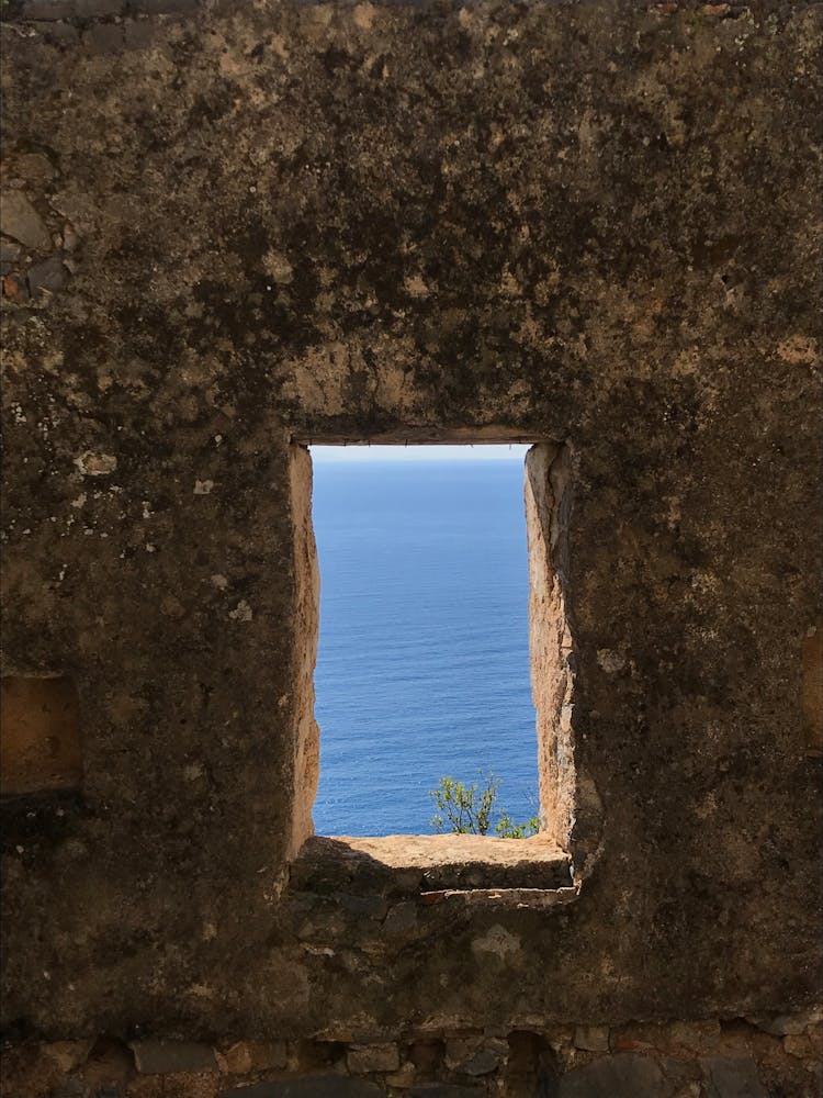 A Rectangular Opening On Wall With A View Of A Sea