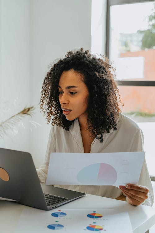 Woman in White Shirt Holding White Printer Paper