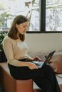 Woman in White Sweater Using Laptop Computer