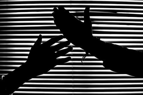 Free Silhouette of Hands With Venetian Blinds Background Stock Photo