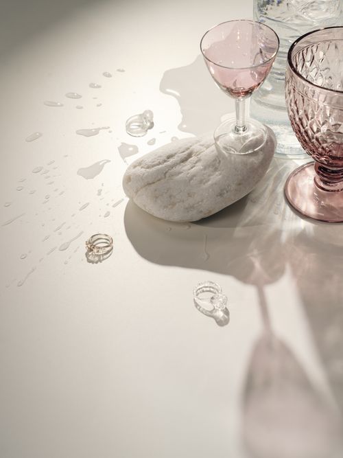 Free Aesthetic composition featuring glasses and rings on a marble surface with water droplets. Stock Photo
