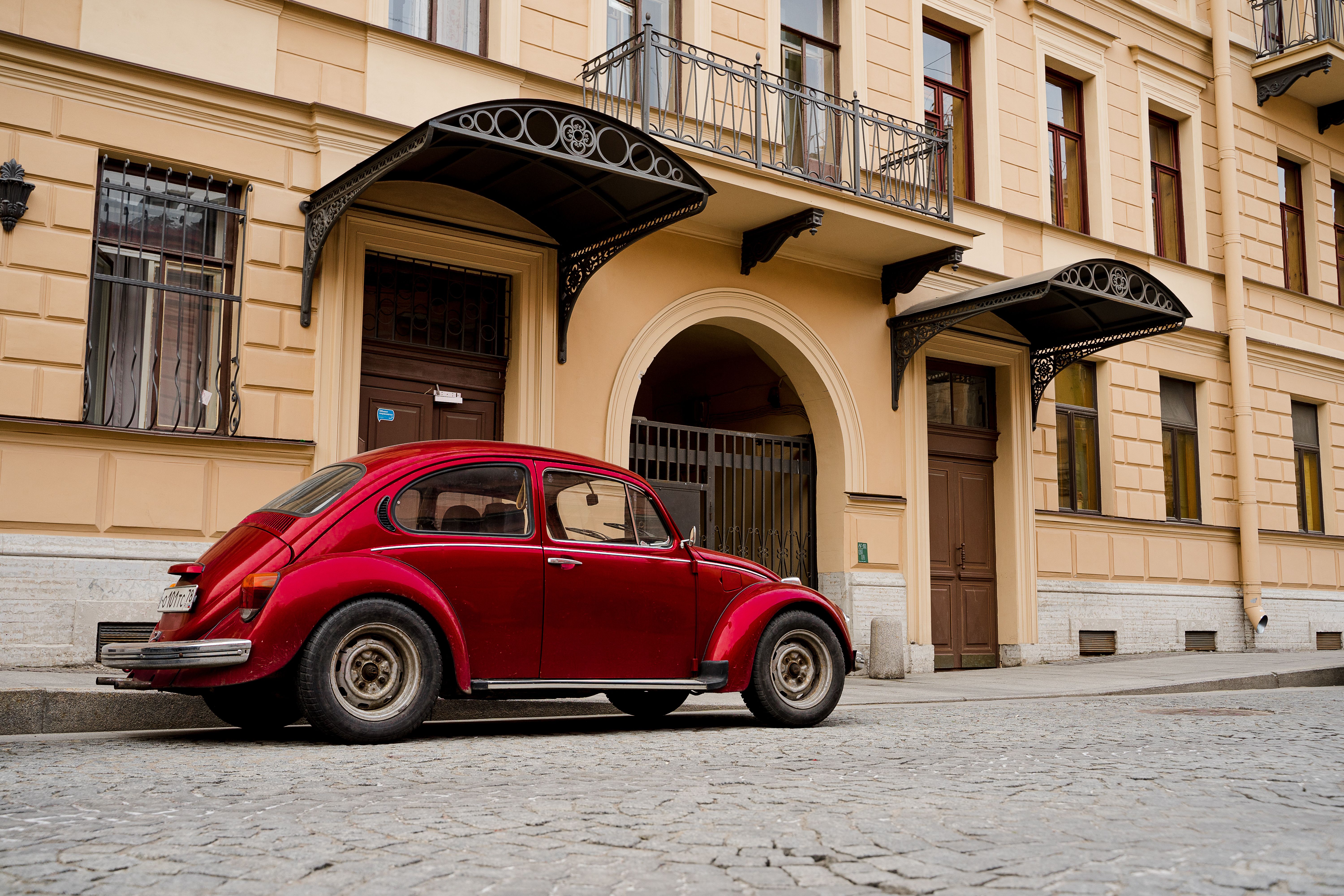 Vintage Red Car Parked in Front of Building · Free Stock Photo