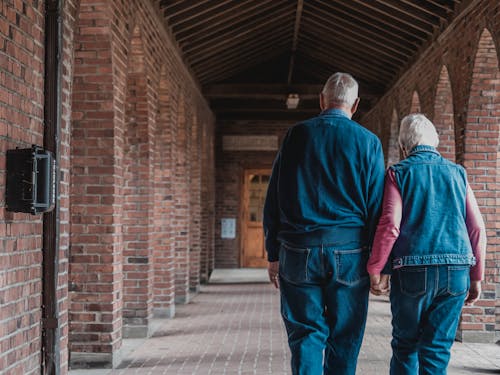 Free Old Couple Walking while Holding Hands Stock Photo