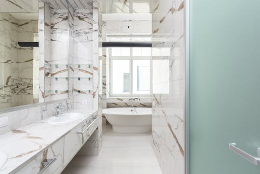A stylish bathroom featuring a marble design and contemporary bathtub, ideal for luxury interiors.