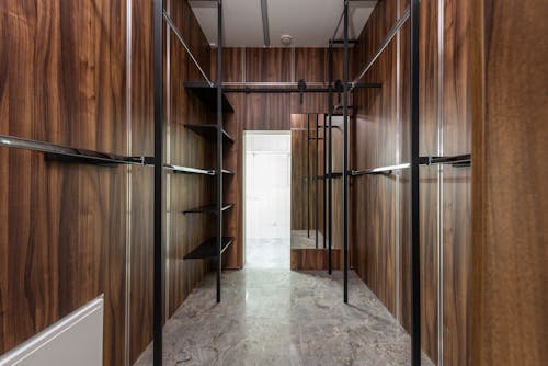 A Brown Wooden Walk in Closet