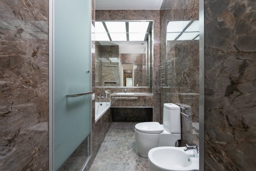 White Ceramic Toilet Bowl Near the Sink