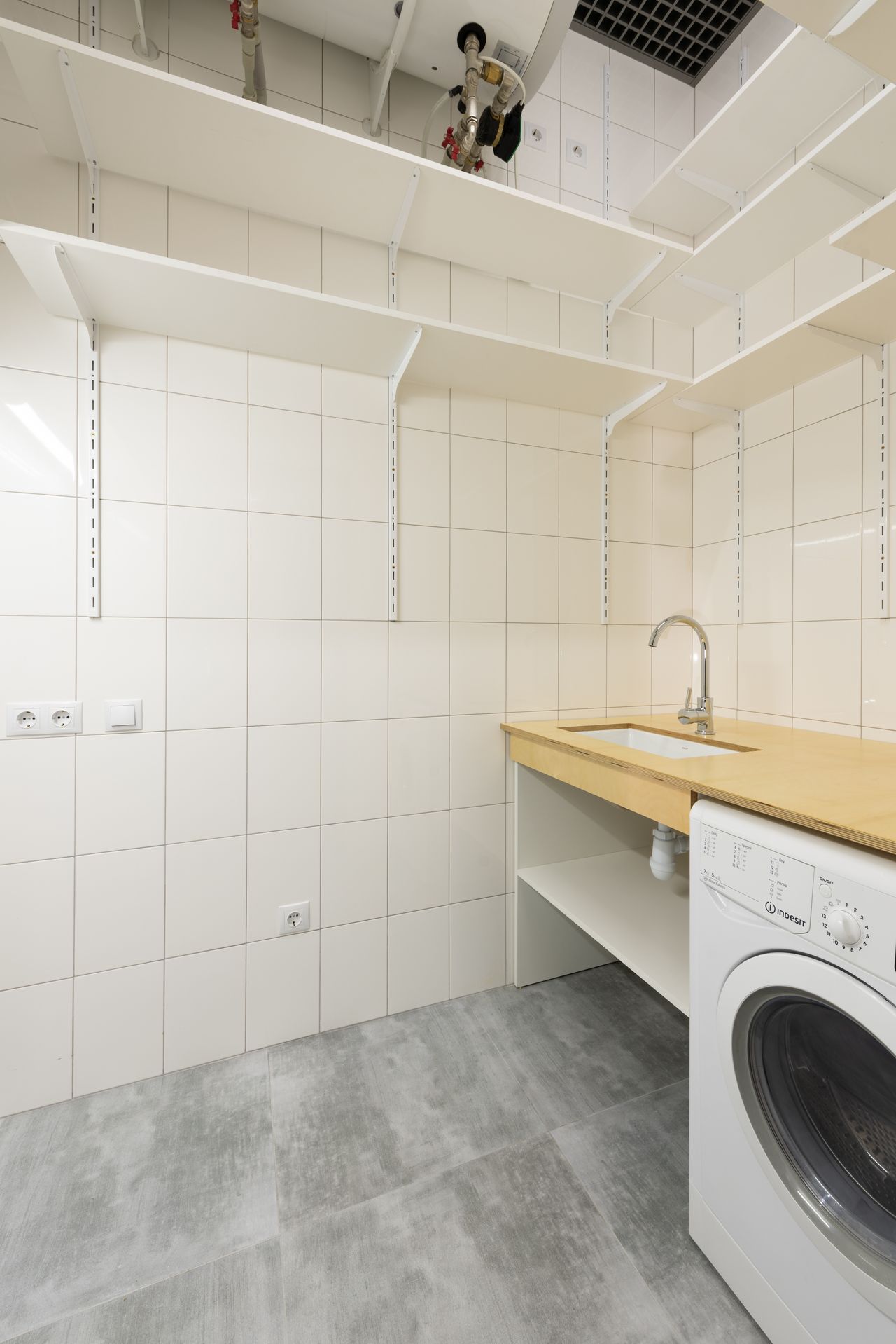 Clean organized laundry room with tidy shelves