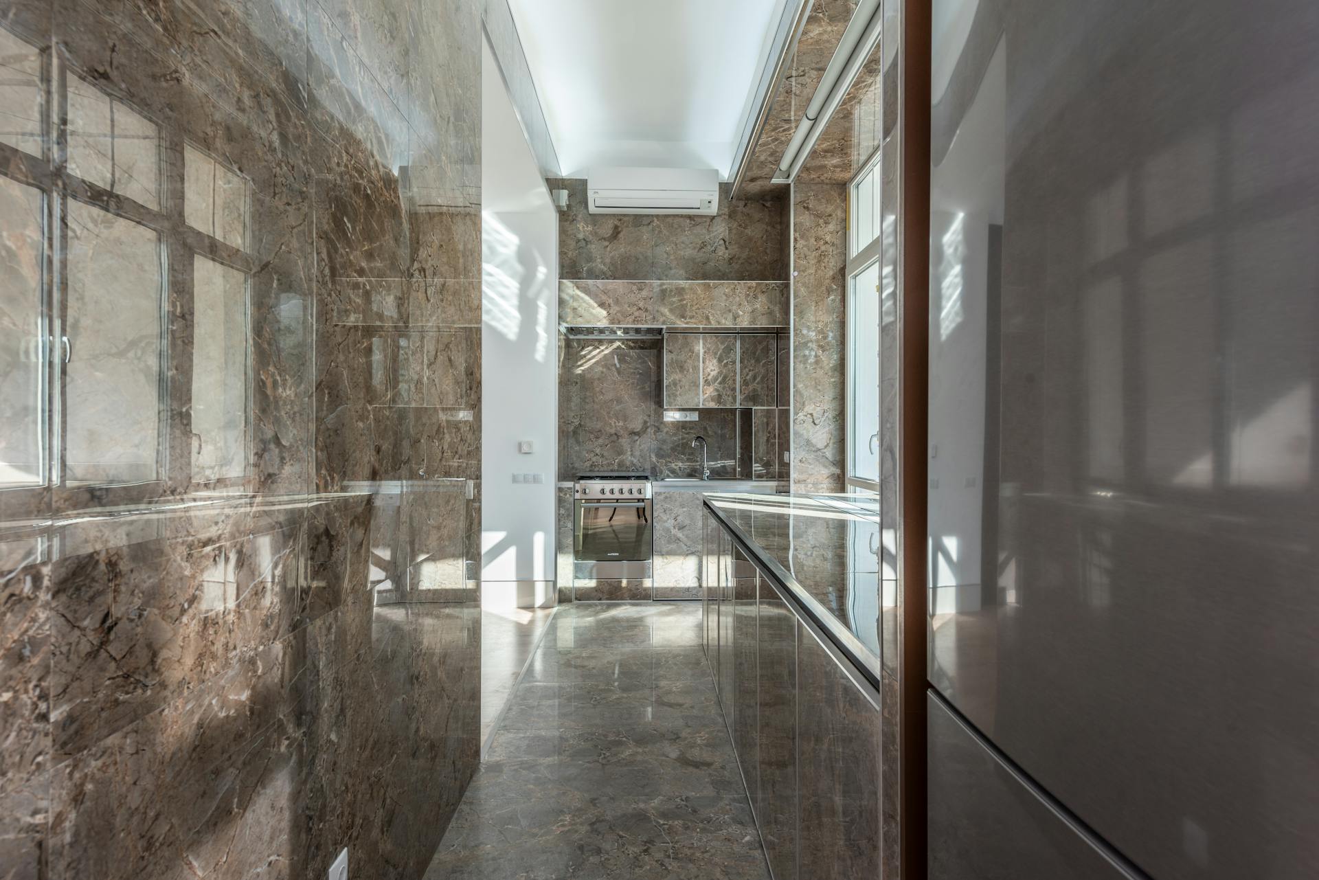 Sleek and elegant marble kitchen interior showcasing modern design with high-end finishes.