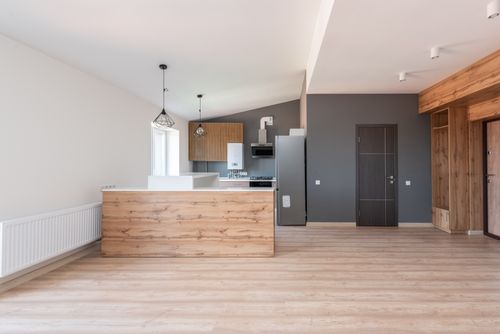 Free Explore a stylish and minimalistic open-plan kitchen with wood accents and modern design. Stock Photo