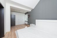 White Bed Linen Near White Wooden Cabinet