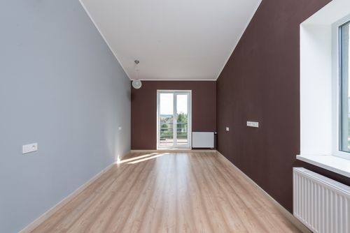 Free Spacious empty room featuring wooden flooring and a large window with natural light. Stock Photo