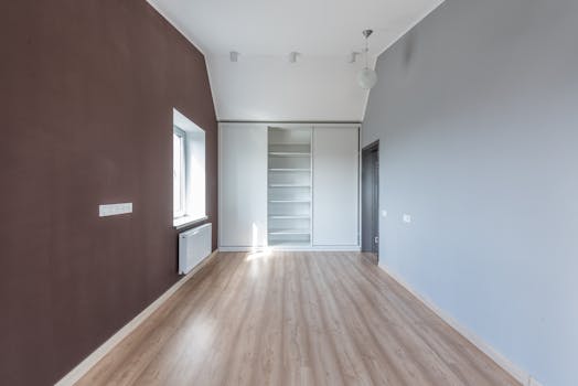 A spacious, minimalist room with wooden flooring and natural light. Perfect for interior design ideas.