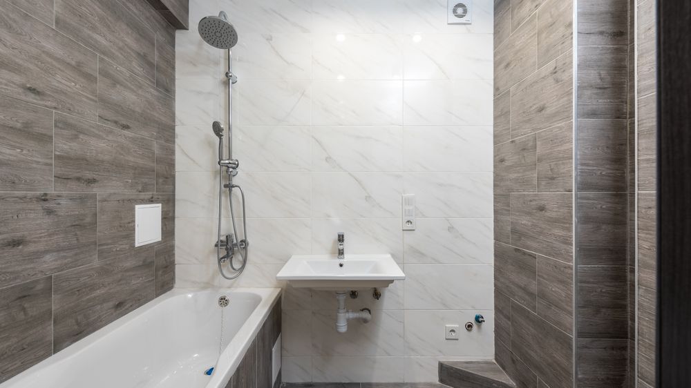 Elegant modern bathroom interior with wooden details and sleek design.