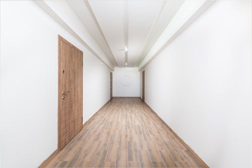 Free An Empty Hallway with White Walls Stock Photo