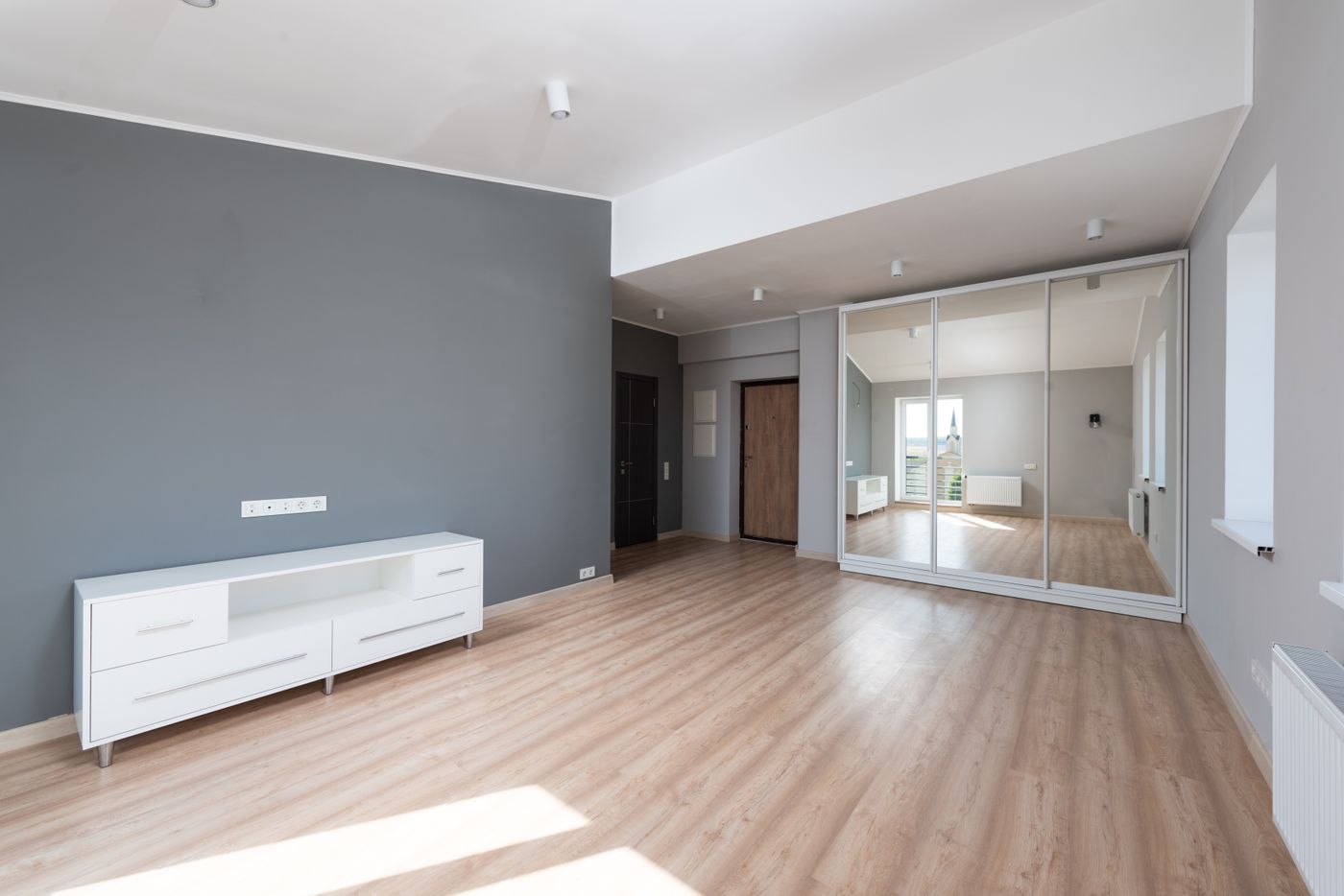 Spacious empty room with wooden flooring