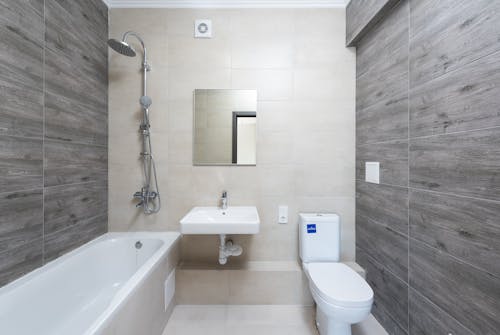 White Ceramic Bathtub beside White Ceramic Sink