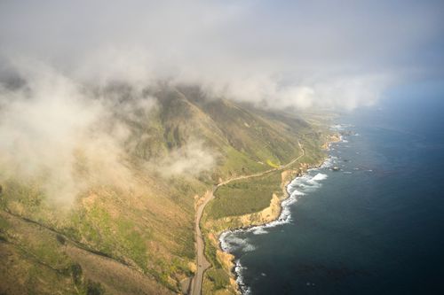 Free Breathtaking aerial photograph of Big Sur, CA coastline with fog and ocean waves. Stock Photo
