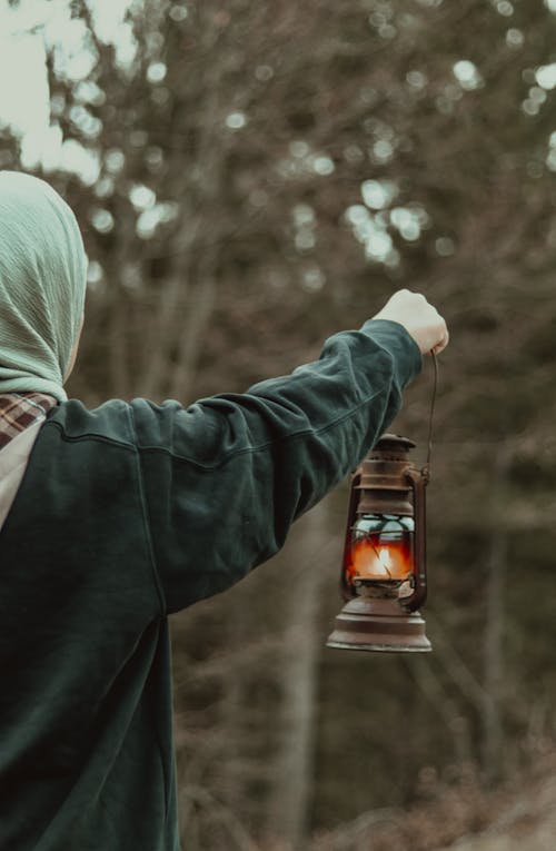 A Person Holding an Oil Lamp