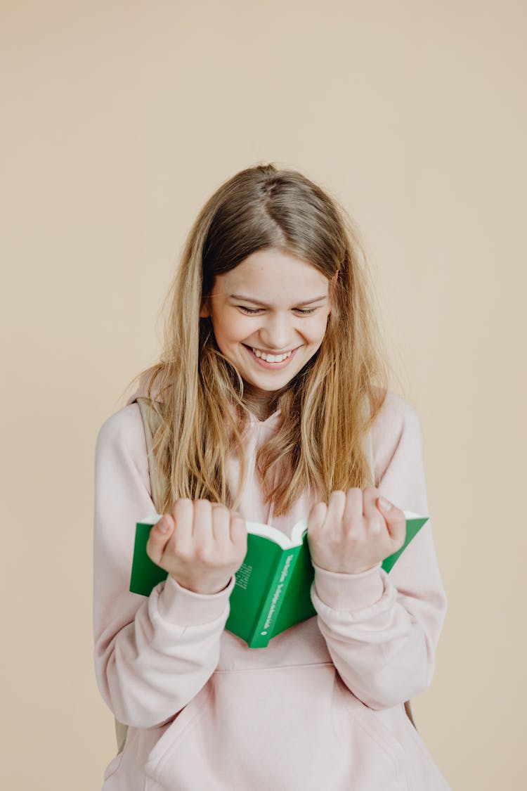 A Happy Teenager Reading A Book