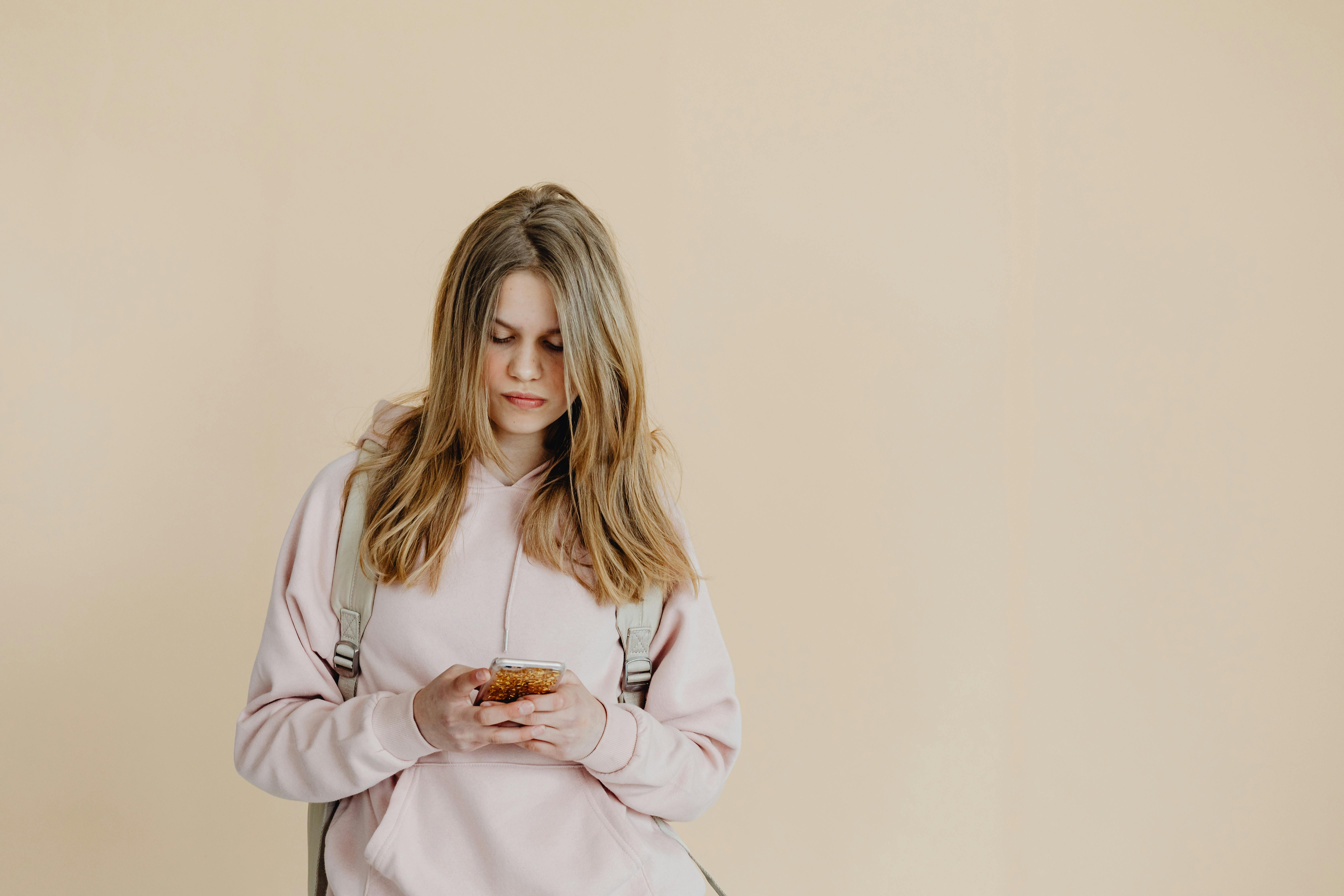 a teenager using her smartphone