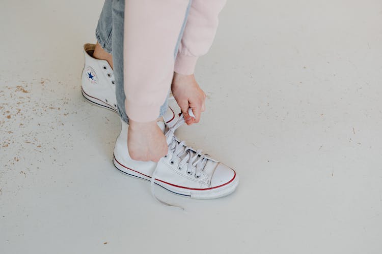 Person Wearing A White Converse Sneakers