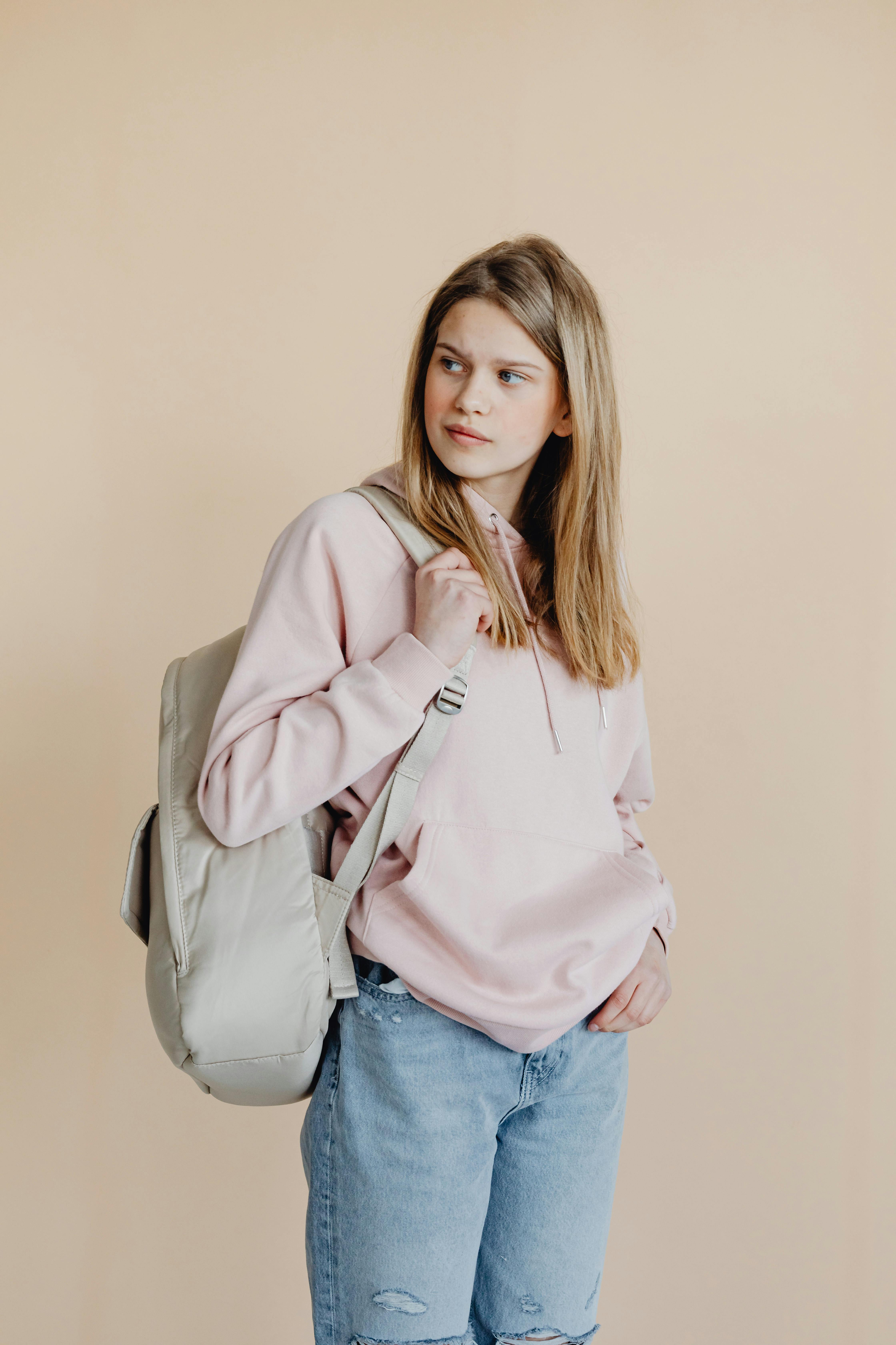 a girl carrying her backpack