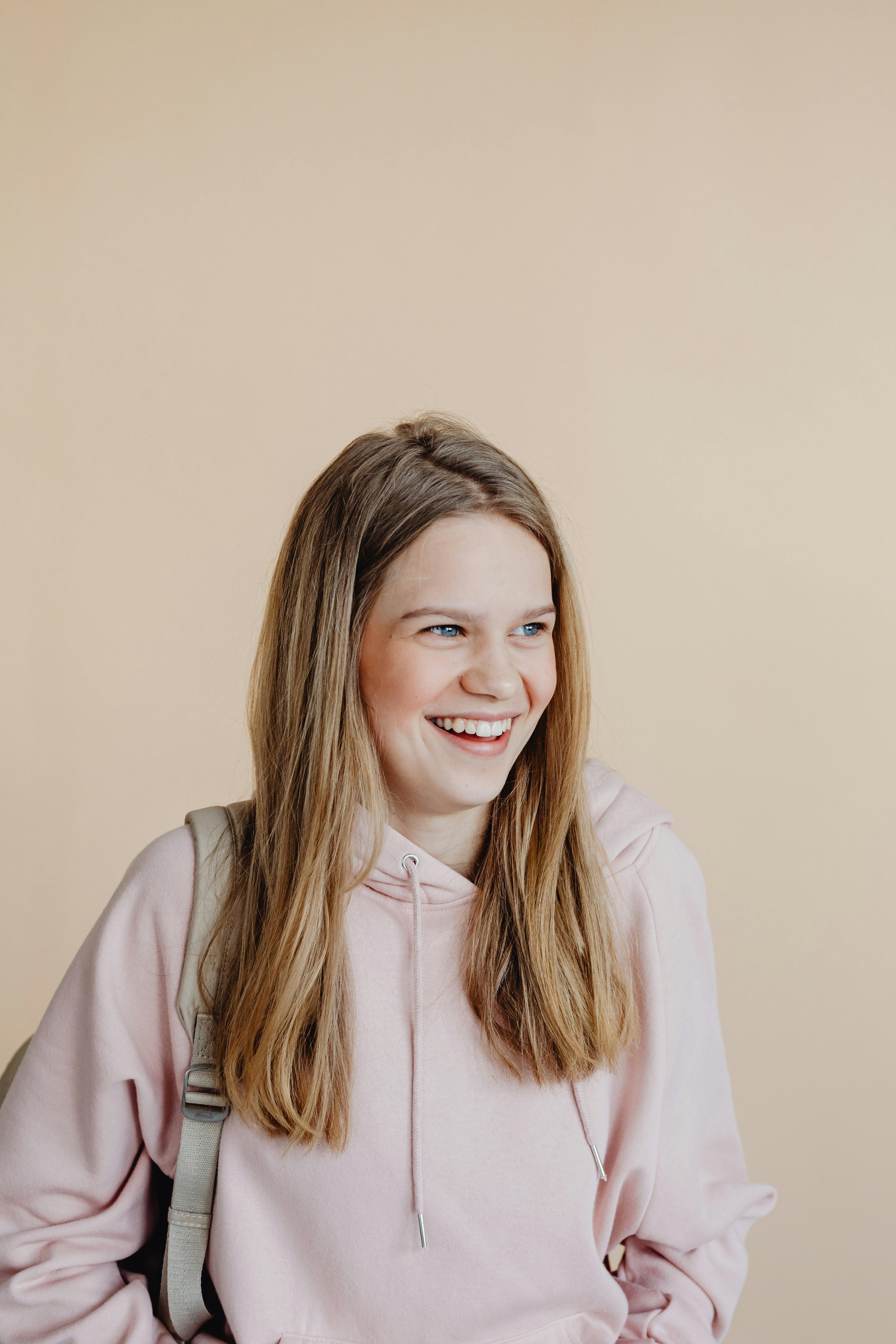 a woman in beige hoodie