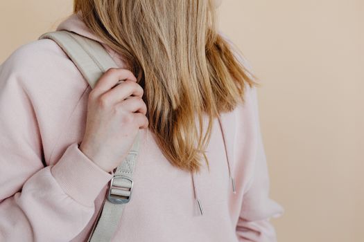 A Student Holding a Backpack Strap
