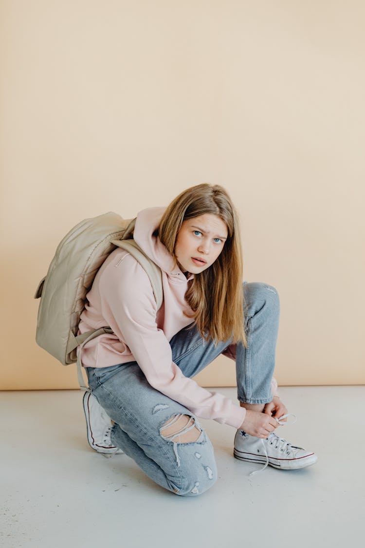 A Teenager Tying Her Shoelace