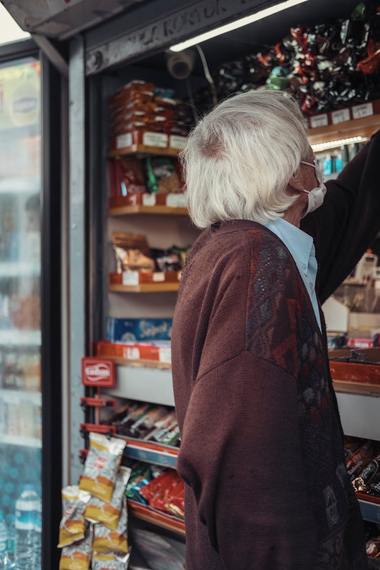 Unrecognizable Old Man Choosing Goods In Supermarket