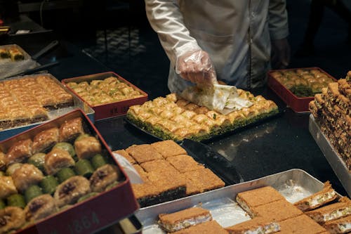 Free Crop seller with assorted Turkish sweets in shop Stock Photo