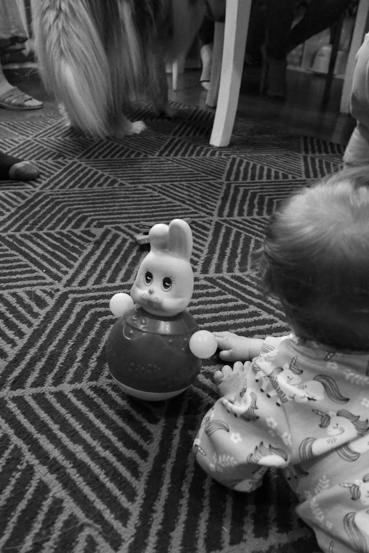 Baby Lying On The Floor With A Toy 