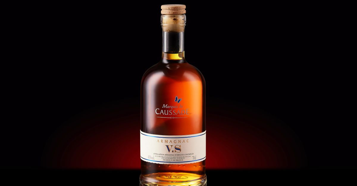 A bottle of Armagnac VS with a cork, elegantly displayed against a dark background.