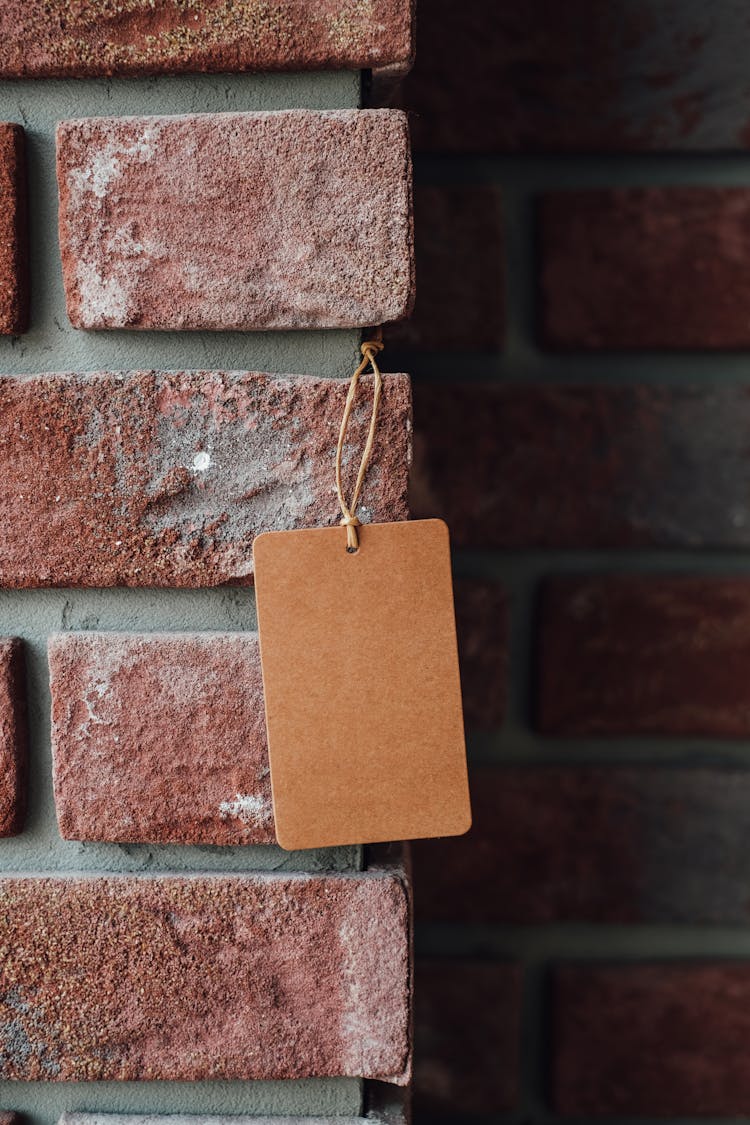 Kraft String Tag On Brick Wall