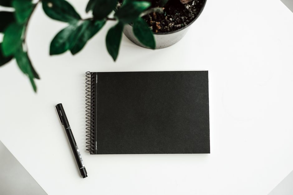 notebook and pen on desk natural light lifestyle photo 2