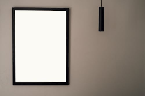 Black Picture Frame Mounted on Brown Wall