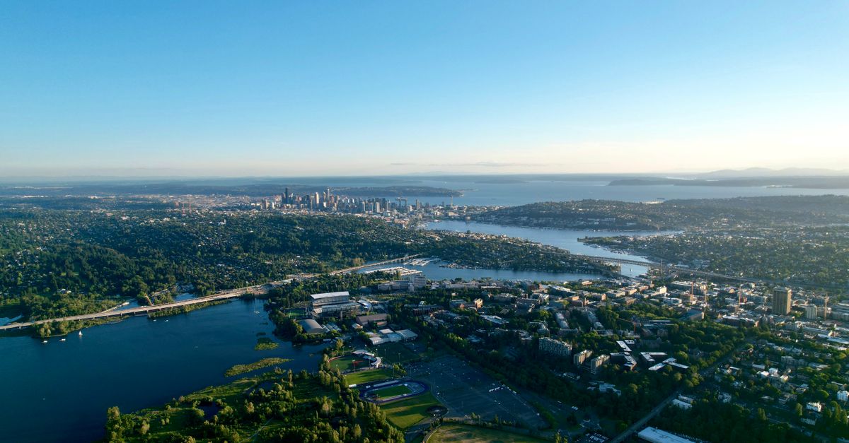 Stunning aerial view of Seattle's skyline and Lake Washington under a clear blue sky.