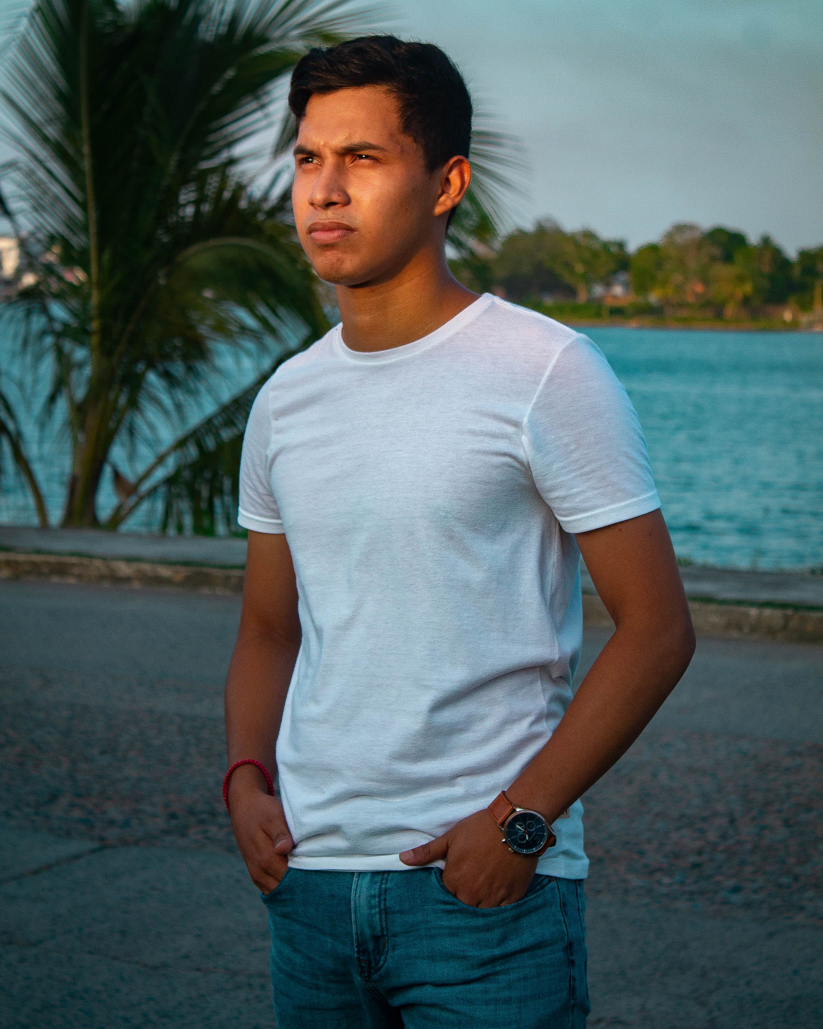 Casual portrait of a young man standing by the waterfront in Tuxpan, Mexico during daytime.