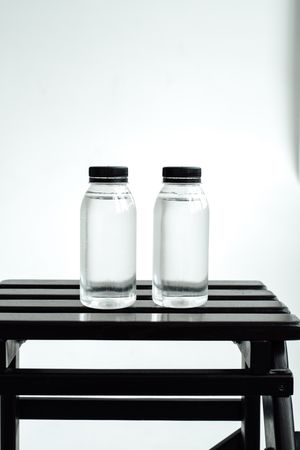 Two clear water bottles in a minimalist setup — photo by Vie Studio on Pexels