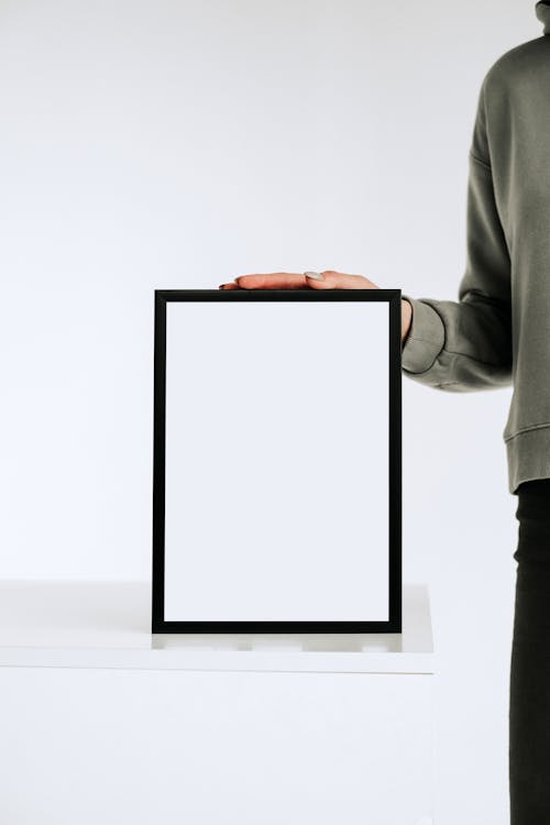 Free Person Holding White and Black Frame Stock Photo
