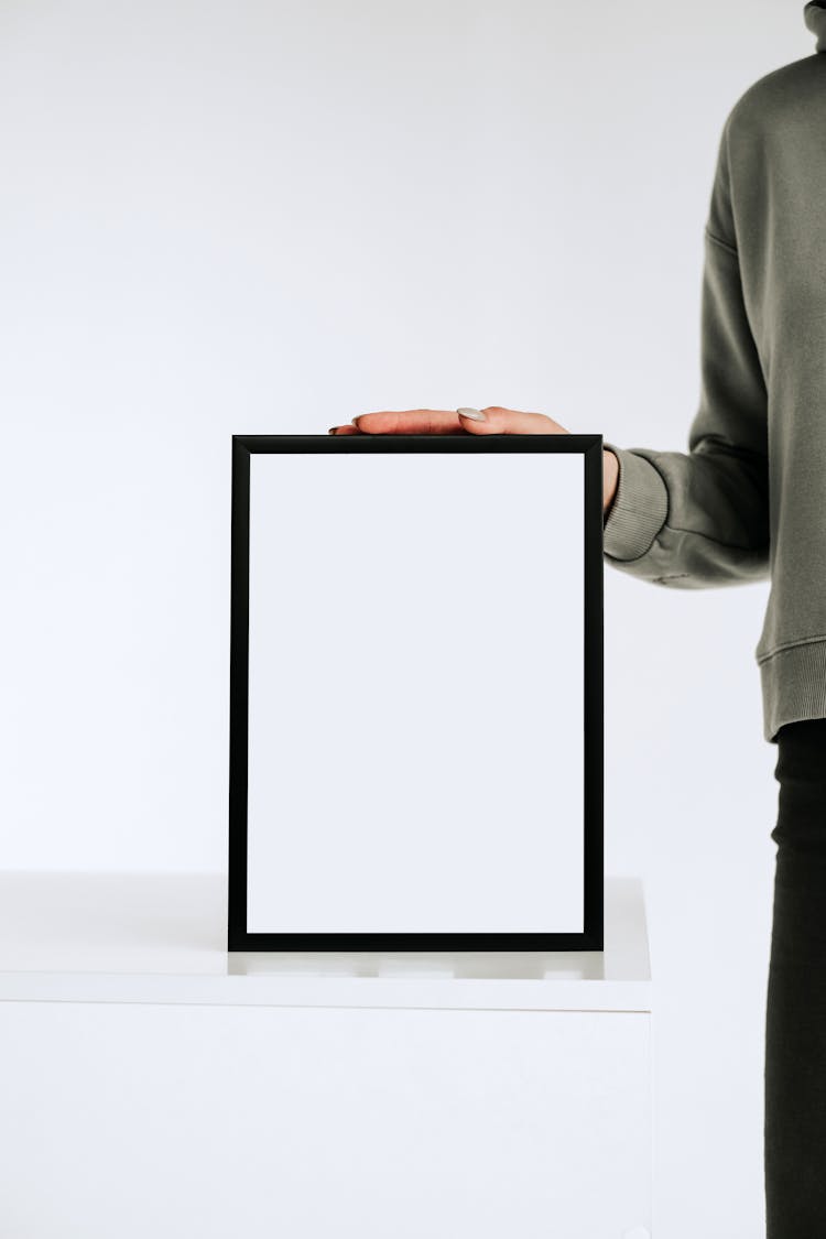 Person Holding White And Black Frame