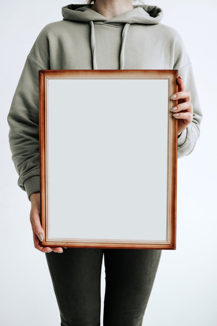 Person Holding A Brown Frame