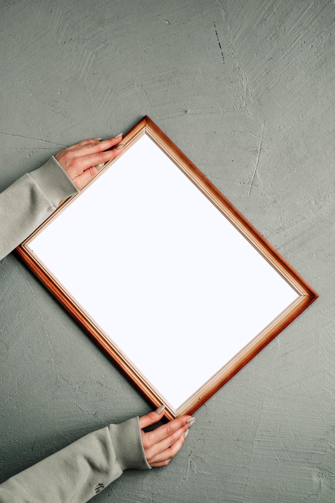 Photo frames — wooden frame held against a wall