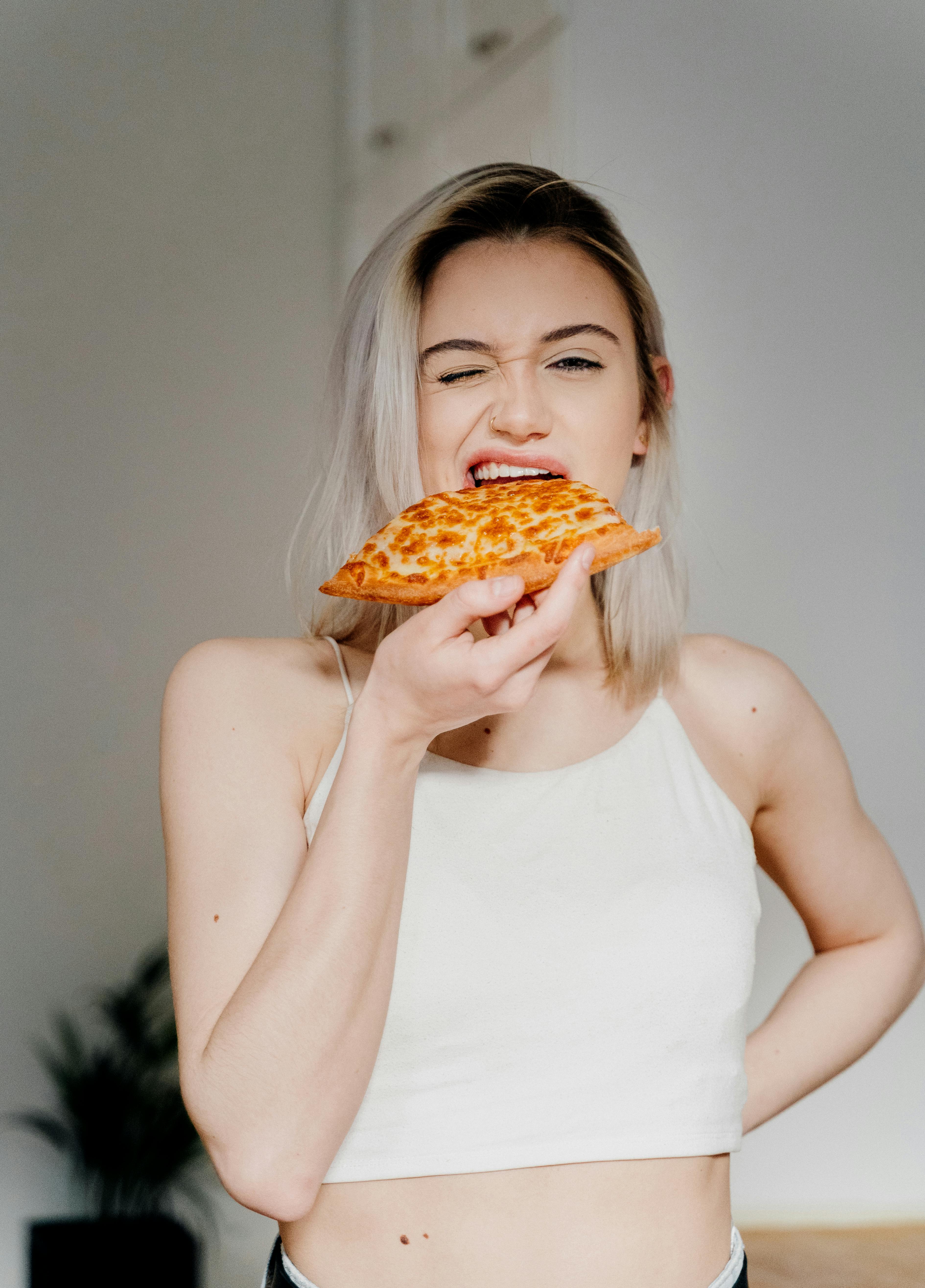 Woman in White Tank Top Holding Pizza · Free Stock Photo