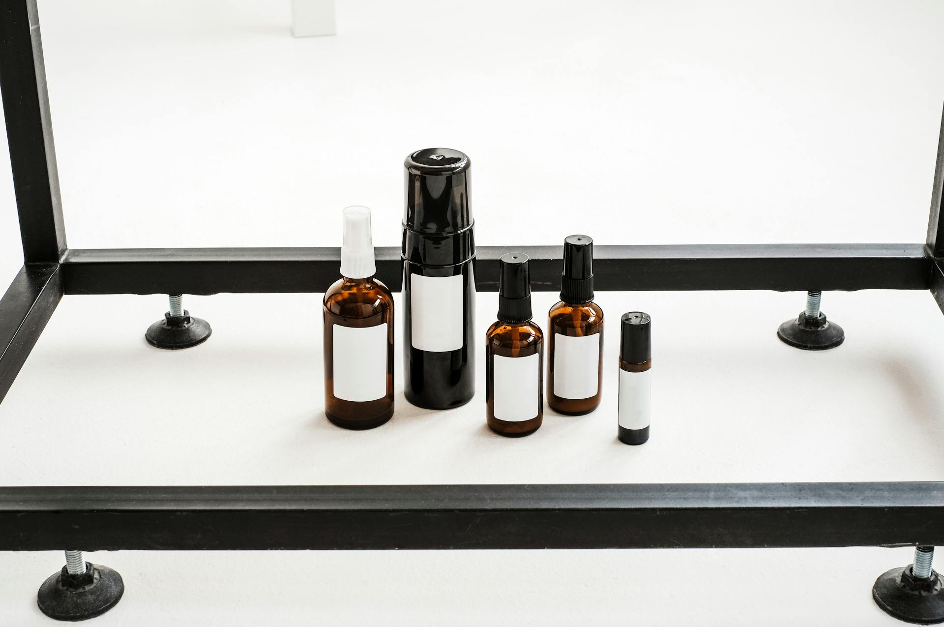 Brown and Black Glass Bottles on a White Table
