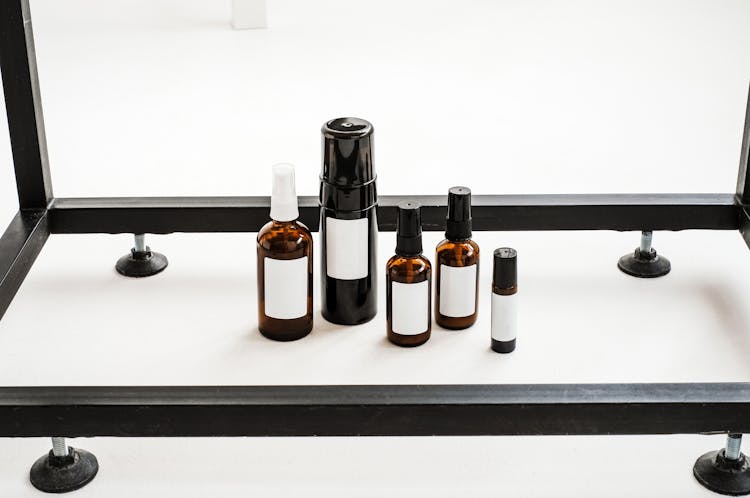 Brown And Black Glass Bottles On A White Table