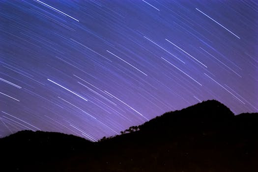 Stunning star trails captured over a mountain silhouette in São Bento do Sapucaí, Brazil.