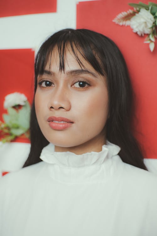 Woman in White Turtleneck Shirt Smiling at the Camera