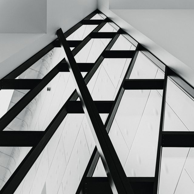 Geometric glass and steel roof structure seen from below — photo by Gilberto Olimpio on Pexels