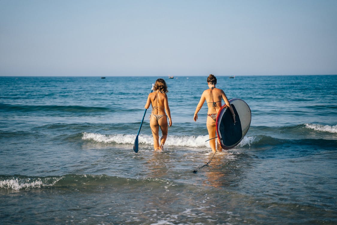 Women in Bikini Walking towards Sea